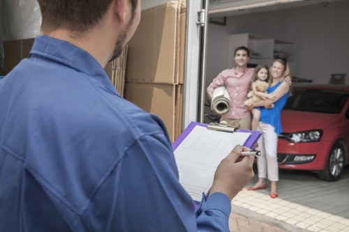 Professional movers protecting furniture and doorways in a home