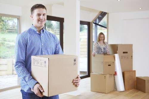 Local movers handling furniture carefully in an Aperfield property