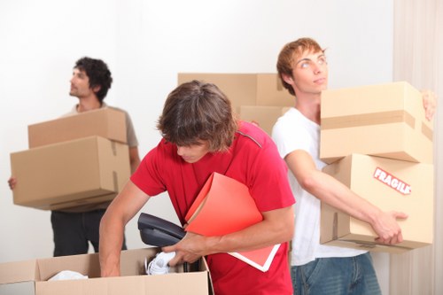 Movers handling commercial furniture with care in a local property