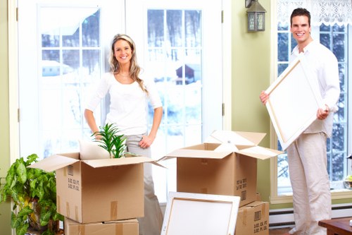 Packed boxes and furniture ready for a moving van in Aperfield