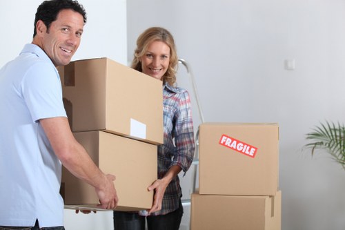 Packed boxes and furniture ready for transport with a moving truck in Aperfield